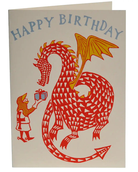 A square birthday card with a cream background featuring a stylized red dragon and a small figure giving a gift, with the words “HAPPY BIRTHDAY” printed at the top in blue.
